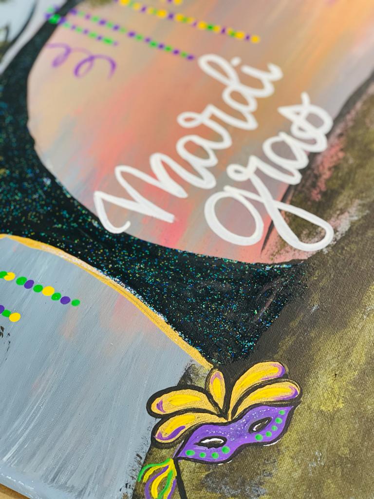Mardi Gras mask and tree trunk painting with words Mardi Gras
