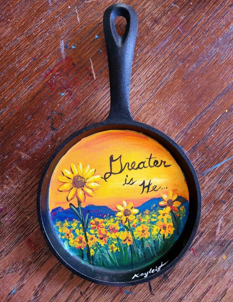 sunflower landscape painted on a cast iron skillet by Kayleigh Smith