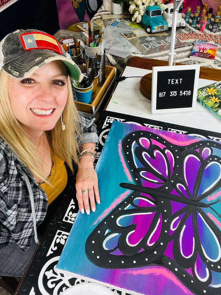 heidi easley with her colorful butterfly painting