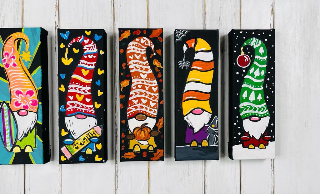Hand painted gnomes hanging on a wall